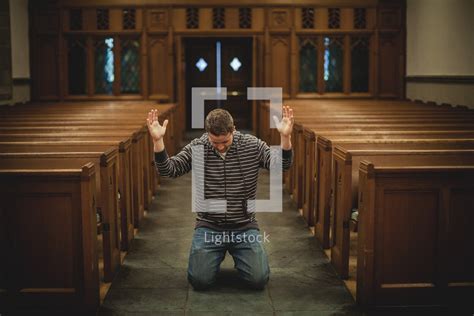 Stock Photo Man Kneeling In Prayer With Hands Raised By Shaun Menary