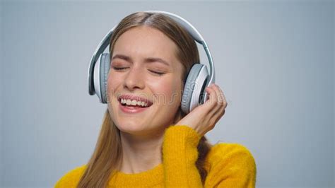 Closeup Smiling Woman Listening Music In Headphones On Grey Background