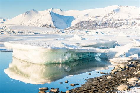 Jokulsarlon Glacier Lagoon With Floating Icebergs And Reflection