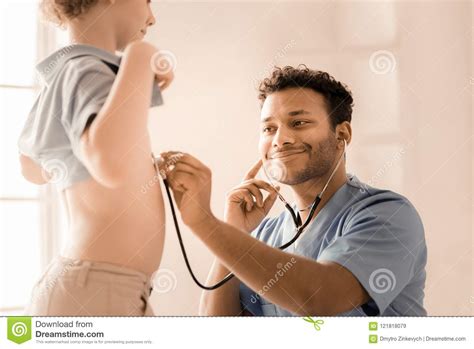 Positive Delighted Medical Worker Treating Boy Stock Image Image Of