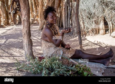 Damara Woman Sitting In The Shade With Painted Cheeks At The Damara Living Museum Namibia