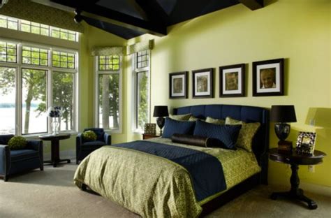 Here, a fun rattan bed frame and colorful tropical bed linens paired against the deep, navy wall give this space a trendy island look. Fresh and relaxing green bedroom designs and ideas