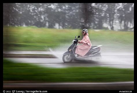 I have ridden once or twice in the rain but don't feel confident when i do. Picture/Photo: Scooter rider in the rain on parkway ...