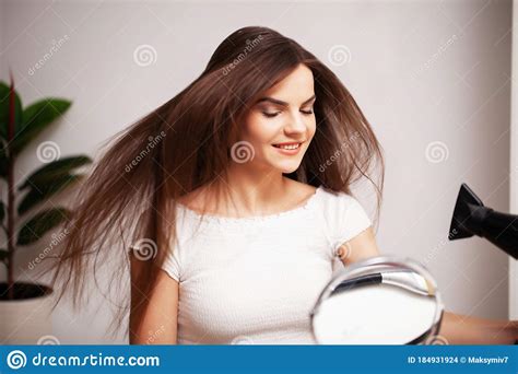 Beautiful Woman Uses A Hair Dryer To Dry Her Hair After A Shower Stock Photo Image Of Makeup