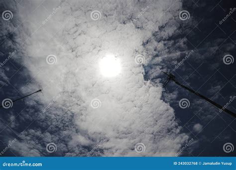 The Sun Shines Through Altocumulus Clouds With A Clear Blue Sky