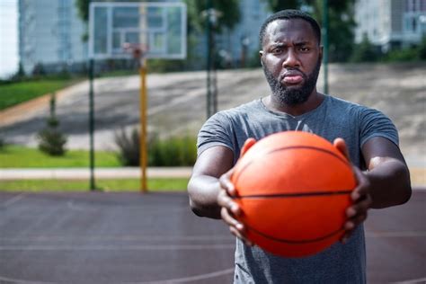 Free Photo Man Holding A Ball On Basketball Court Medium Shot