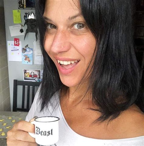 A Woman Holding A Coffee Mug In Her Right Hand