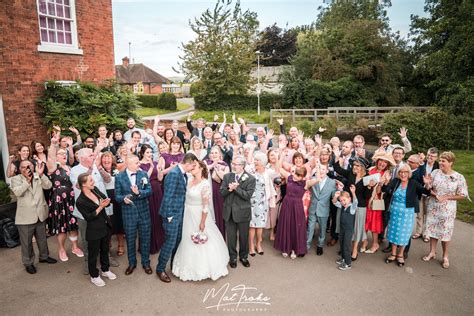 Group Photo Bride And Groom Kissing And Guests Cheering At Rufford Mill