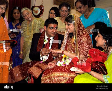 Hindu Engagement Putting Engagement Ring On Finger During Ceremony At