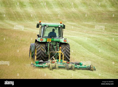 Farmer Mowing Field Of Grass Using John Deere Tractor Stock Photo Alamy