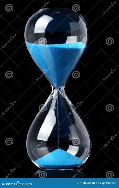 Hourglass With Blue Sand Showing The Passage Of Time Stock Photo