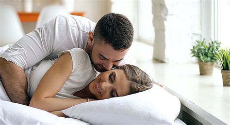 Young Beautiful And Loving Couple Wake Up At The Morning Attractive Man Kiss And Hug His Wife