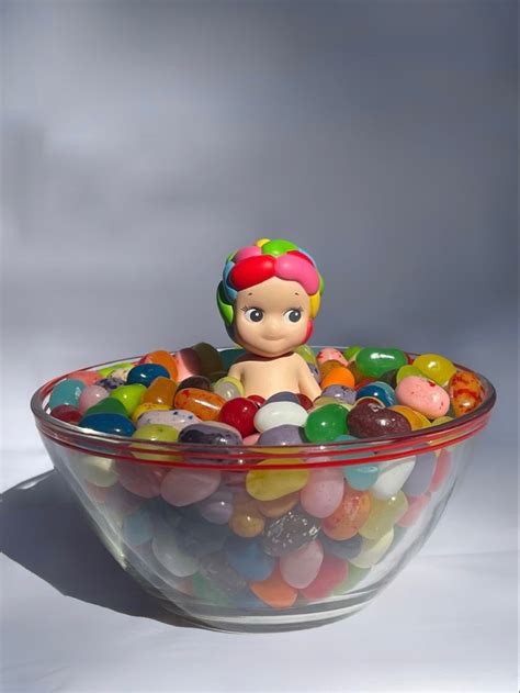 A Bowl Filled With Gummy Bears Sitting On Top Of A Table