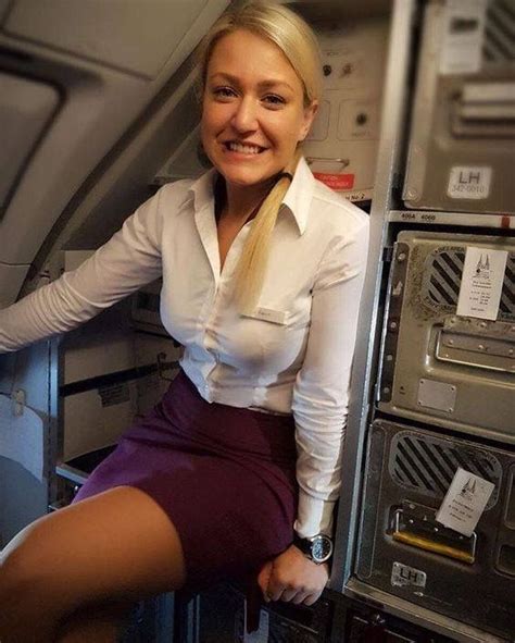 Female Flight Attendant In White Shirt And Dark Red Dress Airline