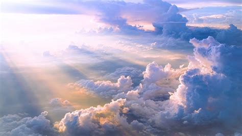 The Sky Is Filled With Lots Of Clouds And Sun Beams Shining Down On Top