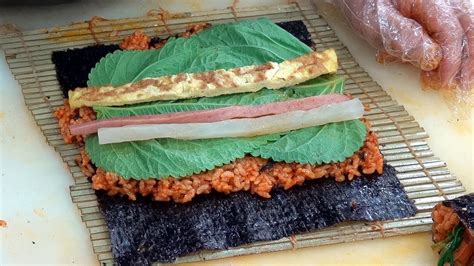 To assemble, place a sheet of nori seaweed onto a sushi rolling mat lined with saran wrap. Korean Street Food - Gochujang Gimbap (Dried Seaweed Rice ...