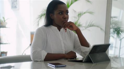 Thoughtful Black Woman Writing Email For Work On Laptop At