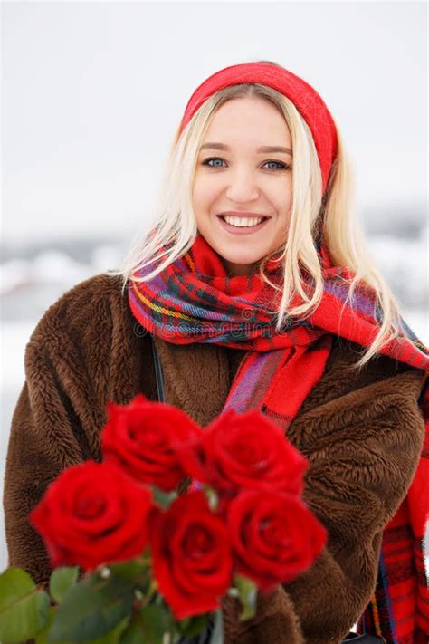 Beautiful Young Girl Gives A Bouquet Of Red Roses Stock Photo Image