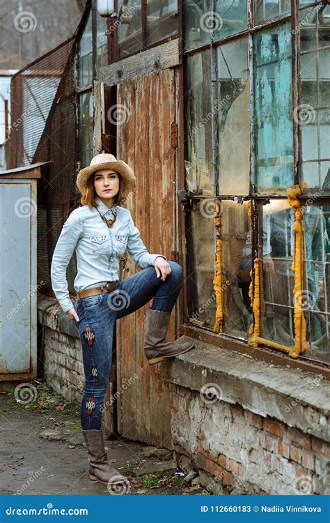 Woman In Western Wear In Cowboy Hat Jeans And Cowboy Boots Stock