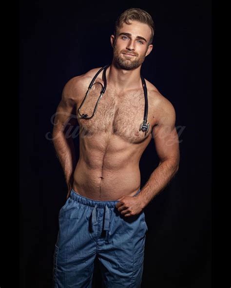 A Shirtless Man With A Stethoscope Around His Neck Posing For The Camera