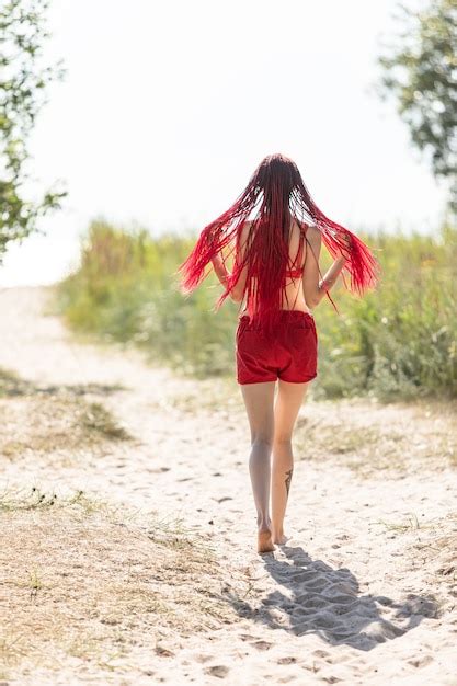 premium photo beautiful girl outdoors enjoying nature seminude girl with scarlet dreadlocks