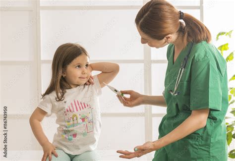 Doctor Checking Little Girls Temperature With Digital Thermometer