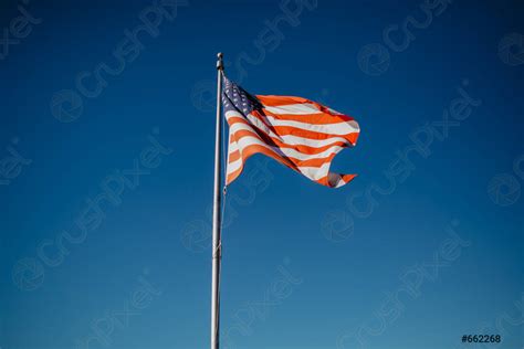 American Flag Waving In Blue Sky Stock Photo Crushpixel