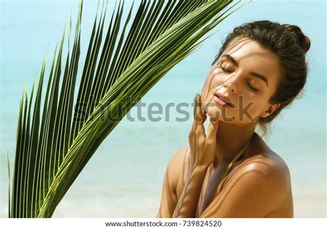 Portrait Of Beautiful Woman With Shadows Of Palm Leaf On Her Face