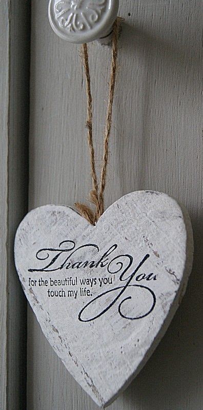 A White Heart Hanging On A Door With A Thank You Sign Attached To It