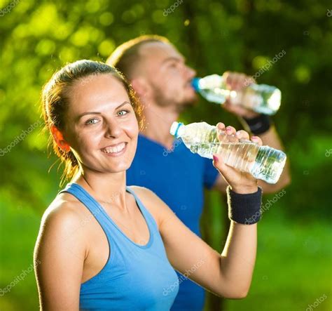Man And Woman Drinking Water From Bottle After Fitness Sport Exercise S Sponsored