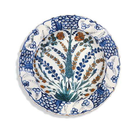 An Iznik Polychrome Pottery Dish With Cypress Tree Roses Prunus And