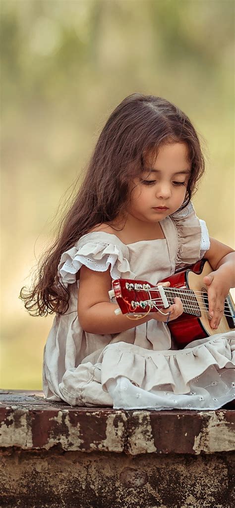 Download Cute Baby Girl Playing Guitar Wallpaper