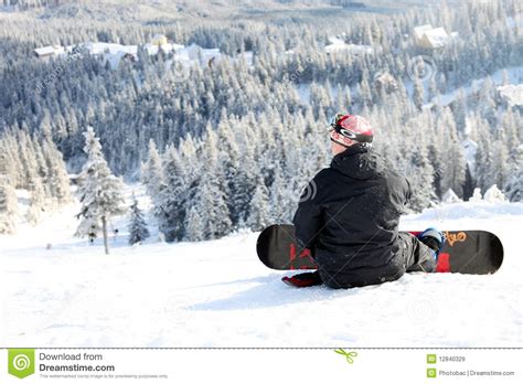 Snowboarder Sitting On A Mountain Slope Stock Image