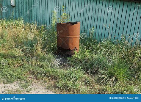 One Red Old Rusty Iron Barrel With A Large Hole Stock Photo Image Of