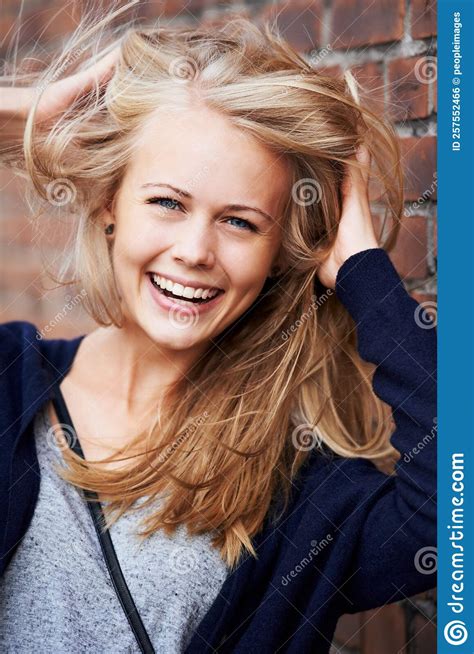 Confident And Beautiful Portrait Of An Attractive Young Woman Leaning