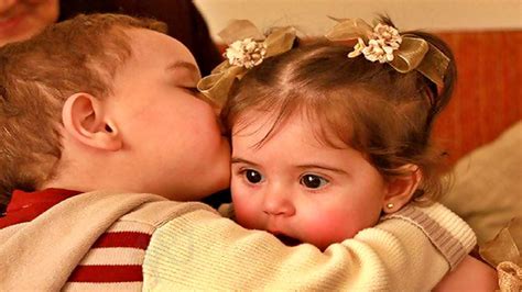 Little Boy Is Kissing Cute Baby Girl Wearing Woolen Dress Hd Cute