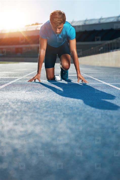 Professional Male Track Athlete In Starting Blocks Stock Photo 123366
