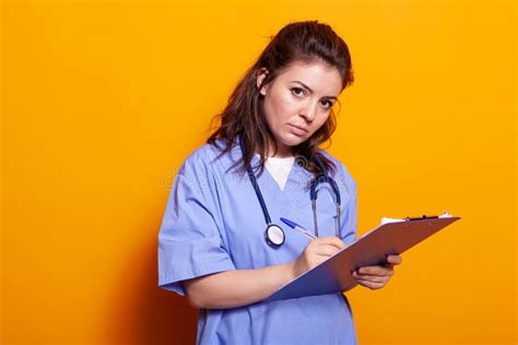 Woman Nurse With Uniform Taking Notes On Clipboard Files Stock Image