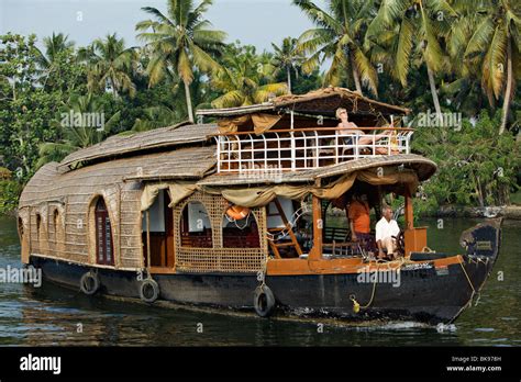 Woman Lounging On A Sundeck Of Kettuvallam A Traditional Style