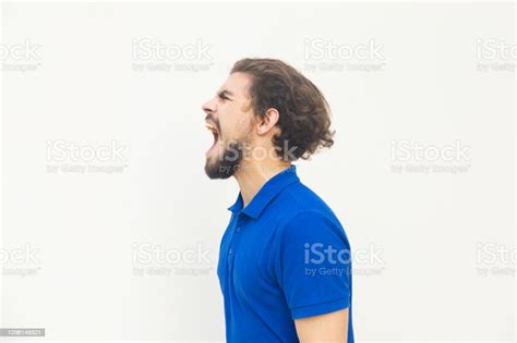 Side View Of Angry Young Man Screaming Stock Photo Download Image Now