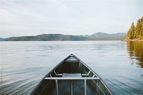 Canoeing Across A Smooth Lake Stocksy United Canoe Priest Lake