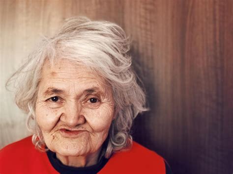 Premium Photo Close Up Portrait Of Smiling Senior Woman Against Wall