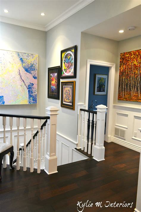 Artwork gallery style walls in entryway and stairwell of this contemporary modern style home ...