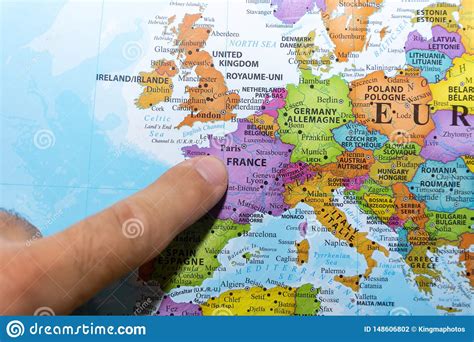Finger Pointing To A Colorful Country Map Of Paris France