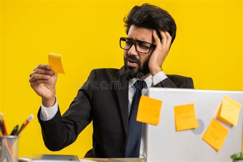 Tired Sad Exhausted Businessman Working On Laptop At Office With Many