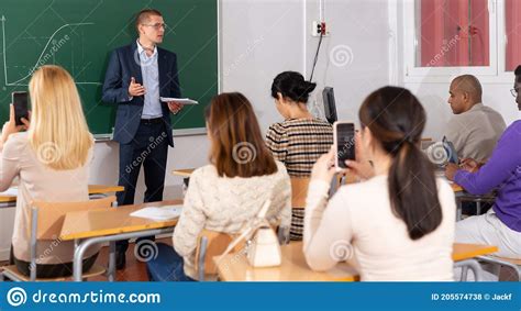 Teacher Explaining New Theme To Adult Students Stock Photo Image Of