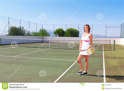 Beautiful Girl With A Tennis Racket Posing For The Press
