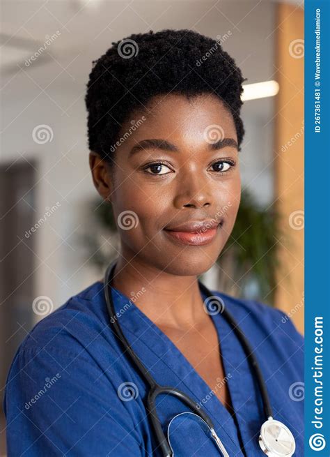 Vertical Portrait Of Smiling African American Female Doctor In Hospital