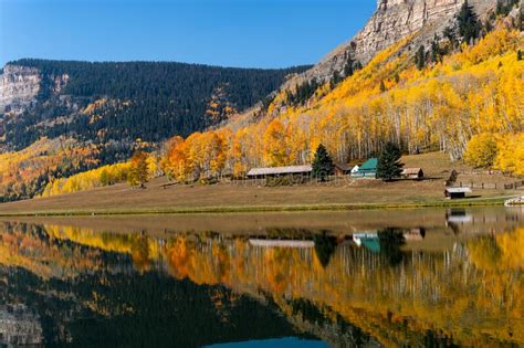 A Cabin Reflection In A Scenic Autumn Landscape With Aspen Trees And