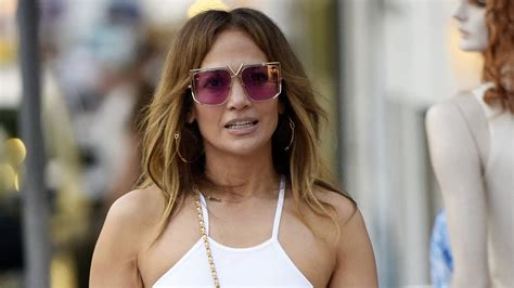 jennifer lopez flashes her toned abs in a white crop top and pink maxi skirt during lavish st